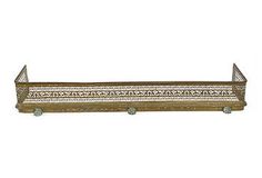 a wooden shelf with two metal brackets on it's sides and an intricate design