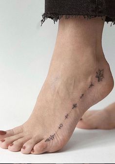 a woman's foot with a small tattoo on it