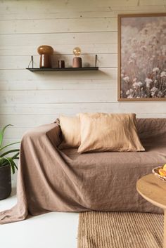 a living room with a couch covered in a blanket