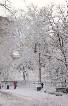 a person walking down a snow covered street