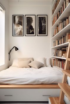 a bed with white sheets and pillows in a bedroom next to a book shelf filled with books