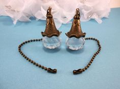 two small bell shaped glass beads on a chain