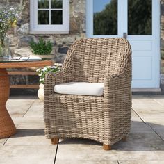 a wicker chair sitting in front of a table