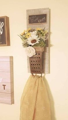 a wall hanging basket with flowers in it