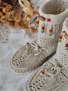 Off-White Beaded Crochet Boot For Women A pair of ethnic boot will give you an authentic look that you want! Because of it is knitted by a crochet, won't make your feet sweat.  So, it may be perfect fit even with your summer combine. Hi, welcome to my shop! All items are made in my home. I knit them all with a crochet. Thank you for your visit and please feel free to contact me for any questions!  All my best from Bodrum/Muğla :) Eclectic Crochet, Home In Winter, Boot For Women, Womens Booties, Crochet Boots, Knitted Booties, Beaded Crochet, Booties Ankle Boots, Crochet Clutch