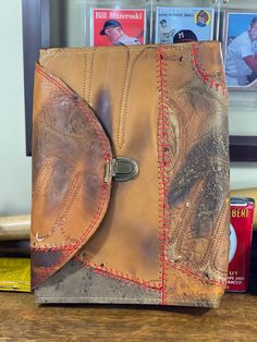 a brown leather purse sitting on top of a wooden table