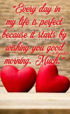 two red hearts sitting next to each other on top of a wooden table with the words, every day in my life is perfect because it starts by asking you good morning