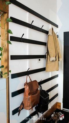 there is a coat rack on the wall with shoes and purses hanging from it