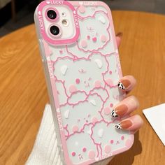 a woman's hand holding an iphone case with hello kitty on it