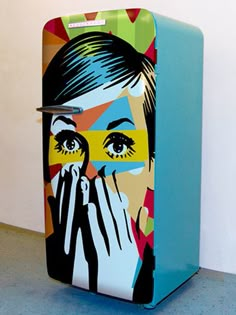 a colorful refrigerator with an image of a woman covering her eyes