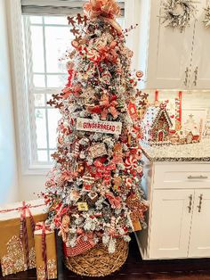 a decorated christmas tree in a kitchen