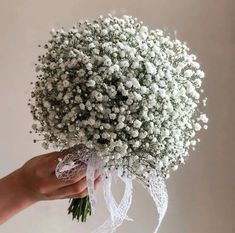 a bouquet of baby's breath in someones hand