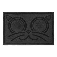 a black door mat with a cat's face drawn on the front and side