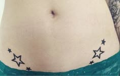 a woman's stomach with stars on it and the bottom part of her belly