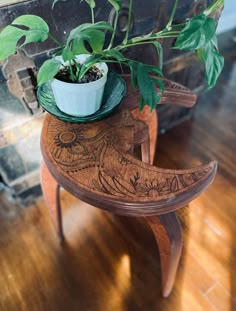 a potted plant sitting on top of a wooden table