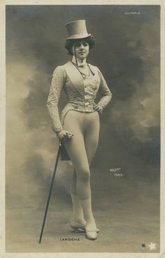 an old fashion photo of a woman in tights and top hat with a cane