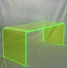 a neon green table sitting on top of a white sheet