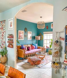 a living room filled with furniture and pictures on the wall above it's doorway