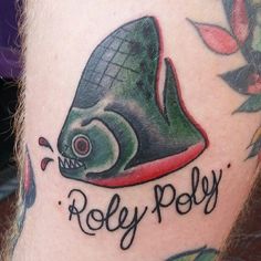 a close up of a person's leg with a tattoo on it that says, roley poly