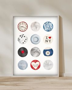 a white framed poster with different types of buttons on it's sides and the words i love new york written in red