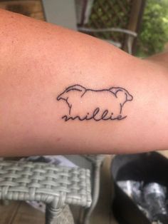 a person with a tattoo on their arm that has a sheep in the middle of it