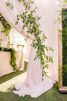 a wedding arch with greenery on it