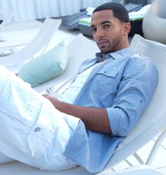 a man sitting on top of a white chair