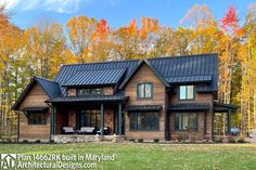 a large house with lots of windows in the front yard and trees on both sides