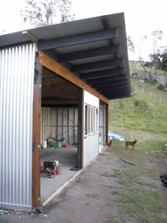 an open garage door on the side of a building with a dog in the background