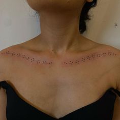 a woman with black dots on her chest