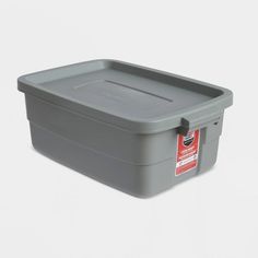 a grey plastic container with a red label on the lid