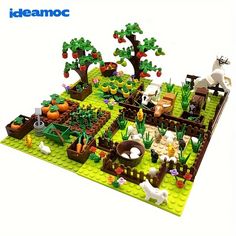 a lego model of a farm with animals and plants on it's sides,