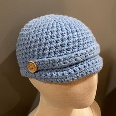 a crocheted blue hat on top of a mannequin's head