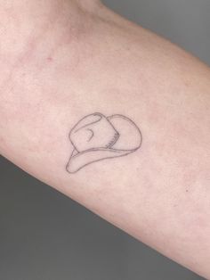 a person's arm with a small tattoo on the left side of their arm