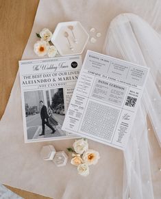 the bride and groom's wedding details are laid out on top of the newspaper