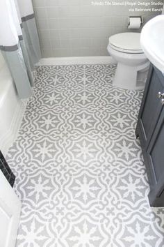 a bathroom with a toilet, sink and bathtub in the same color as the floor