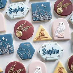 cookies decorated with harry potter and hogwarts symbols are arranged on a white surface