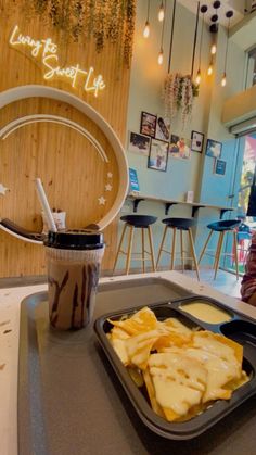 a tray of food sitting on top of a table next to a cup of coffee