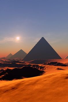 three pyramids in the desert at sunset