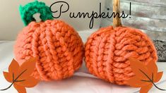 two knitted pumpkins sitting next to each other