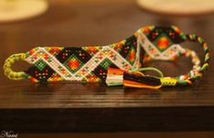 two colorful bracelets sitting on top of a wooden table