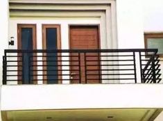 a balcony with two doors and a railing