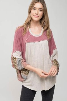 This casual blouse features a flowy knit style with a contrasting pattern detail on the sleeves. Knit Tops With Striped Long Sleeves, Chic Knit Balloon Sleeve Tops, Chic Knit Tops With Balloon Sleeves, Chic Balloon Sleeve Textured Knit Tops, Chic Textured Knit Tops With Balloon Sleeves, Chic Textured Knit Top With Balloon Sleeves, Casual Knit Tops With Striped Sleeves, Oversized Striped Sleeve Tops For Fall, Oversized Bohemian Patchwork Tops