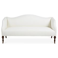 a white couch sitting on top of a wooden frame