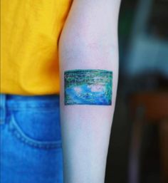 a woman's arm with a small painting on the left side of her arm