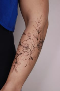 a person with a flower tattoo on their arm