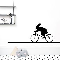 a rabbit riding a bicycle wall decal in a child's room