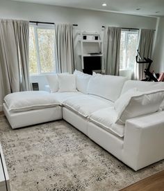 a large white sectional couch in a living room