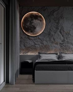 a bedroom with a large moon on the wall