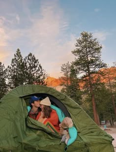 a man and woman sitting in a tent